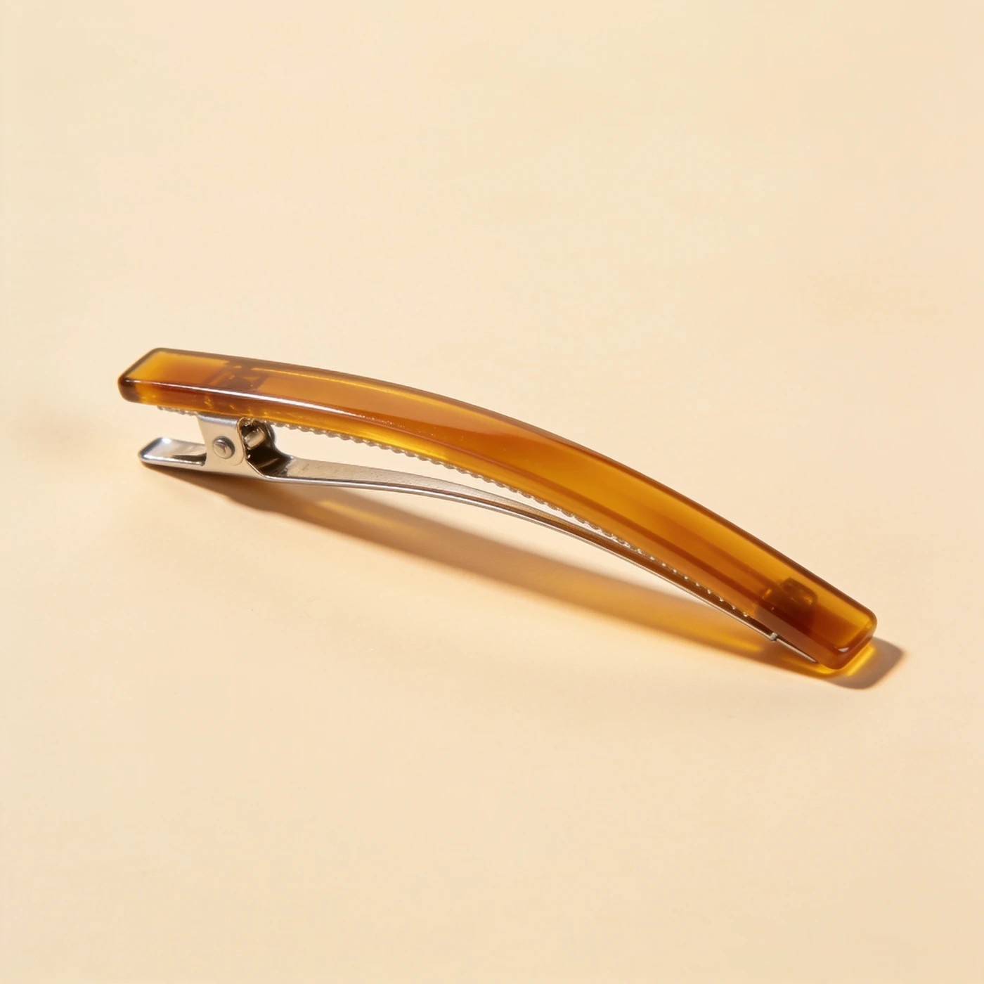 French Barrette Clip — one polished amber acetate curved bar with steel French locking mechanism