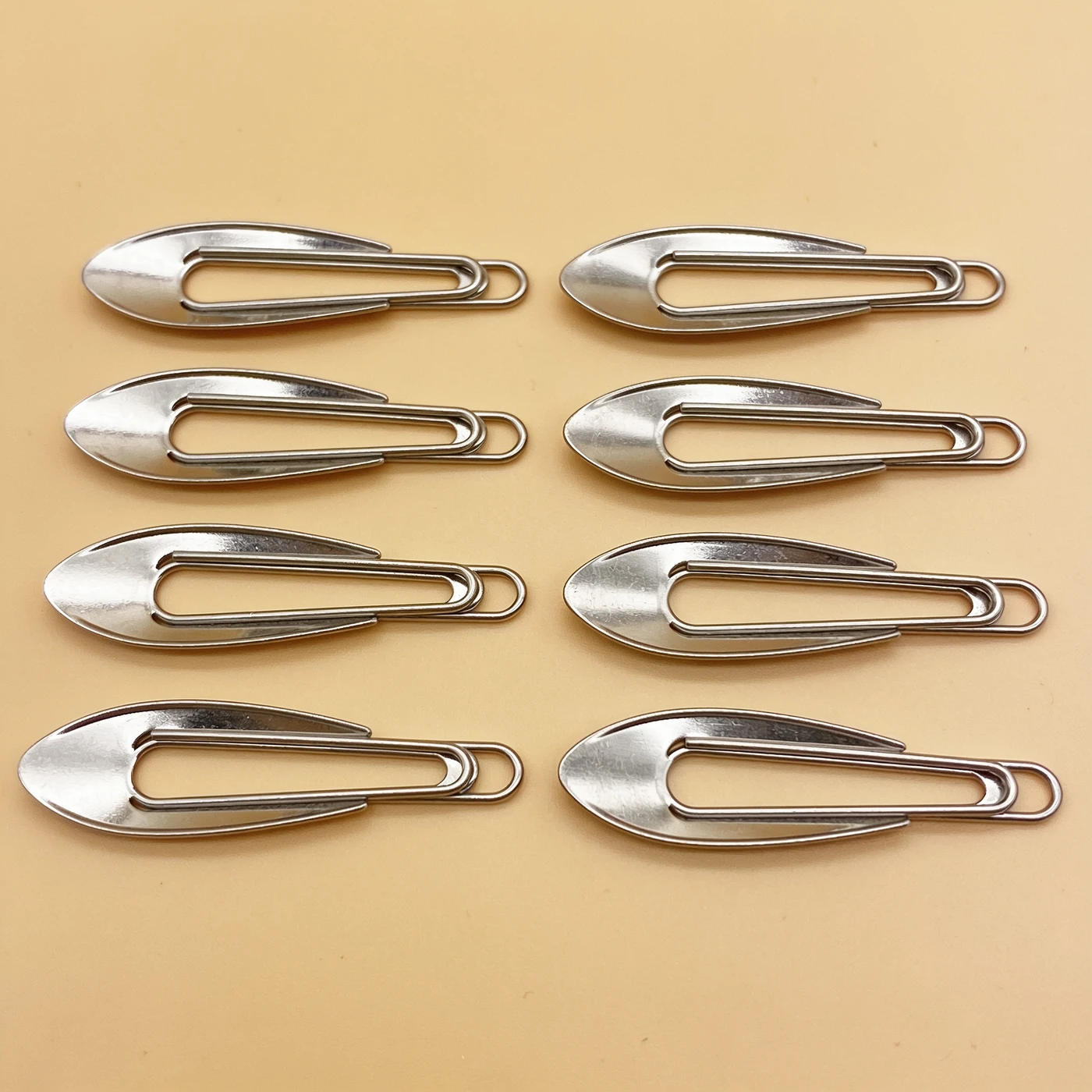 Snap Fringe Clips — eight brushed silver spring-steel snap clips with smooth rolled edges